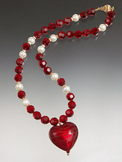 This dramatic necklace features a 1-1/2" fire engine red Venetian glass "puffy" heart suspended from a chain of matching Swarovski crystals.  18"