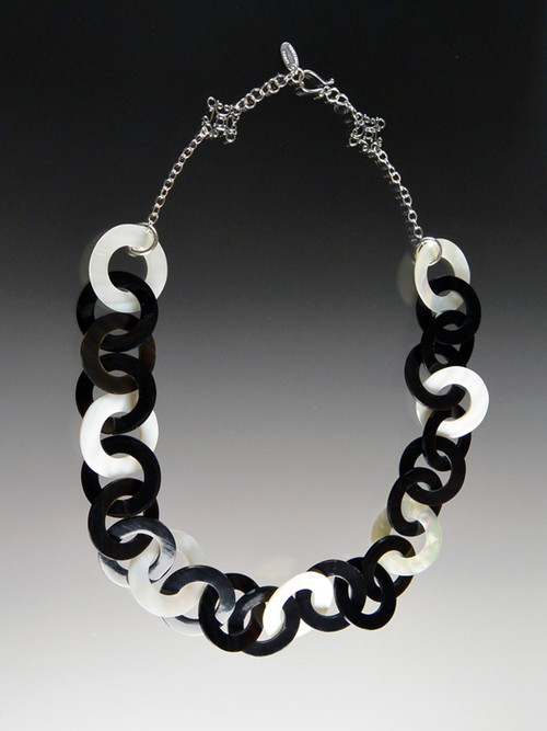 This lightweight on-trend necklace features luminous natural Makabibi shell, black horn, and mother-of-pearl linked circles. It will become your throw on wardrobe staple that carries into all seasons. 18"sterling hook clasp with 2" extender.  Only 6 available.
