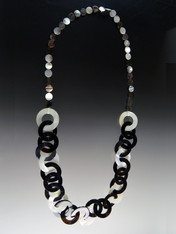 This lightweight on trend necklace features luminous natural Makabibi shell, black horn, and mother-of-pearl linked circles in tones of black, white, and gray with smaller natural mother-of-pearl discs around the neck for extra comfort.  22"  Only 6 available.