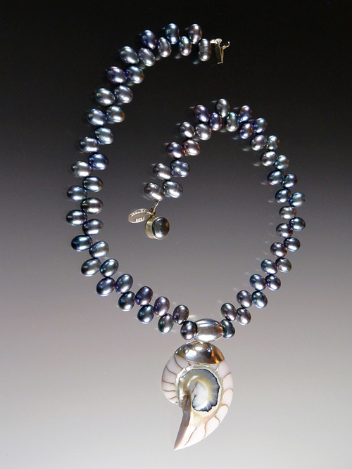 This spectacular 20" necklace features opulent peacock "firecracker" pearls with a magnificent 3" pale blue and white Nautilus Shell sterling silver pendant custom ordered from Bali.