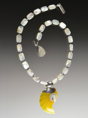 This necklace features a custom ordered Indonesian Natural yellow and white Nautilus Shell with sterling silver bale on a chain of grade AAA faceted mother of pearl tiles, tiny swarovski crystals, and a custom sterling mother of pearl leaf clasp. Necklace 19" Pendant 2-1/5"