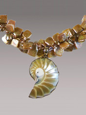 A stunning pale champagne perfectly formed and naturally outlined nautilus shell anchors a necklace of unusual and highly dimensional (suggesting a double strand) square champagne pearls with a fabulous lustre. They can go from day to night without missing a beat.  18" Nautilus Shell 2"
