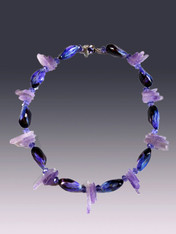 This colorful necklace features natural South Sea violet mactan shells spaced with lavender amethyst shards and a sterling violet Swarovski crystal custom clasp.  Unusual and perfect for right now.  18" 
