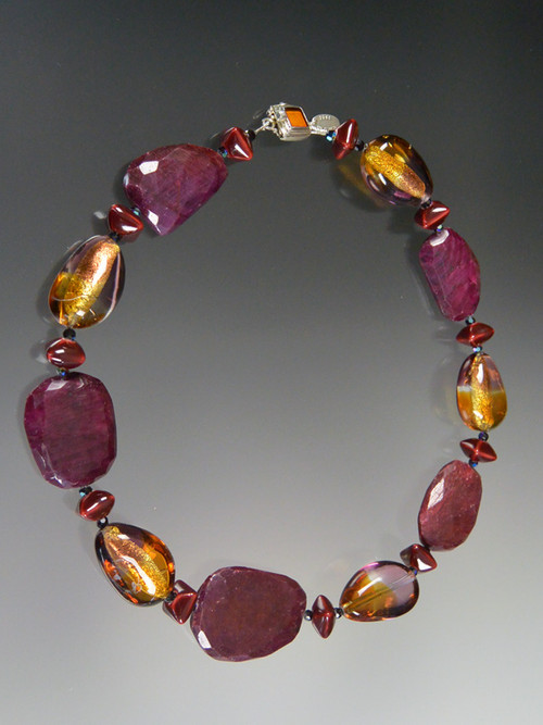This spectacular one-of-a-kind necklace featuares the last of my raw ruby slices, limited edition Venetian tricolor amethyst, amber, 24K gold transparent Lido* pear shaped beads, Greek enameled grenadine stations, garnet Swarovski crystals and a vintage amber clasp. 20"
