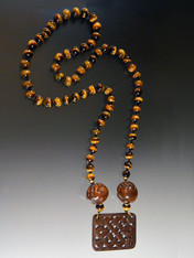 Here's another one of a kind statement piece in the right tones for now and all year round.  The highlight is an amazing hand carved brown jade pendant suspended from a rope with 14K rondels, two large hand-carved vintage Indonesian wooden beads, and silk hand-knotted glowing tigers eye . 28"

 
