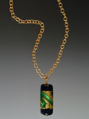This dramatic Venetian glass pendant suspended from a 24K Russian gold plated chain reminds me of a large battery-it is coated with 24K gold foil and bright green swirls. Toss it on and go. 24".  