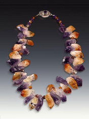 If you like organic dimensional stones, you'll love this dramatic collar. Raw amethyst and citrine freeform clusters make a bold statement and are just right for right now. 18"  (Inquire about longer lengths)

 