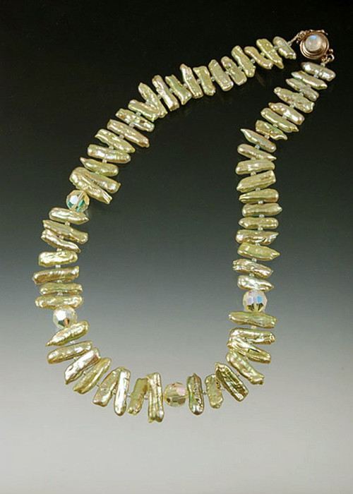 This is totally charming and dramatic in person and goes with almost every color and occasion.  Pale pistachio stick pearls with jonquil Swarovski crystals play off each other for a delicate sparkling collar. 17" (request longer lengths)