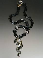   This spectacular necklace features rare Grade AAA trillion cut Brazilian black tourmaline, black Venetian window beads with sterling silver and a luxurious Venetian glass silver and black flecked serpent pendnt. This is truly ONE OF A KIND because I can never find this quality tourmaline again. Necklace 20"  Serpent 3" x 2"