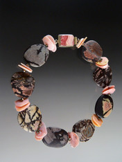 This dramatic and rare Australian Outback Jasper collar makes a bold statement in the season's "in" colors.  Each This dramatic rare Australian Outback Jasper collar makes a bold "earthy" statement.  Outback Jasper was mined commercially for the first time last year in the midwest region of Western Australia, outside Perth. Each freeform stone features intricate natural patterns in shades of dark brown, gray, black, and dusty pink spaced with freeform large pink opal discs and finished with a vintage sterling rhodochrosite csterling clasp. Clasp will vary. 20"  ONLY THREE AVAILABLE