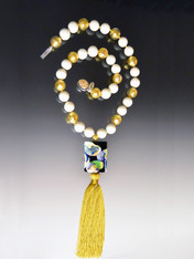 This stunning on trend necklace features a limited edition "Van Gogh" Venetian glass rectangle with silk-knotted ivory and 24K gold foil venetian glass beads, a luxurious gold silk tassel, and a gold druzy sterling clasp.   Necklace 30" Silk Tassel 4-1/2"