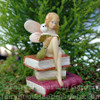 Miniature Fairy Reading on a Stack of Books