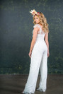 This beautiful bridal jumpsuit competes with any traditional wedding dress. The Melendez is made with incredibly rare gold threaded bridal lace from France. The elegant wide legs are finished with a soft scalloped edge and the pretty capped sleeves offer flattering balance to any figure.