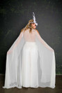 Add the Valentim cape to any House of Ollichon piece to create a striking, modern spin on the traditional veil. This stunning draped cape is made from silk chiffon providing an illusion over layer. You can wear the Valentim in three ways; cold-shoulder, Sherlock cape, or slung around the elbows.