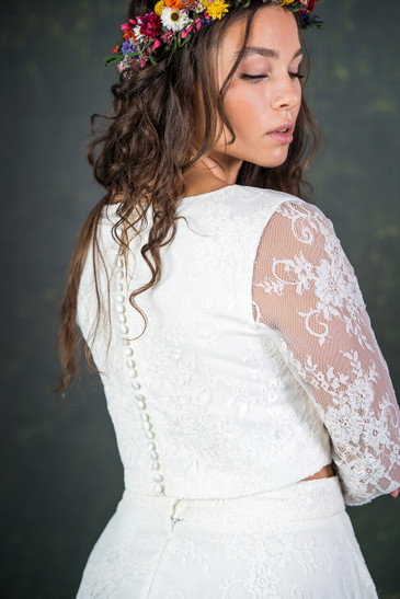 A classic and traditional styled bridal top with sheer, illusion lace sleeves. This ¾ sleeve length bridal top has a flattering boat neckline and pretty covered buttons running down the back. The Le Fay top features here with the Le Fay skirt. 