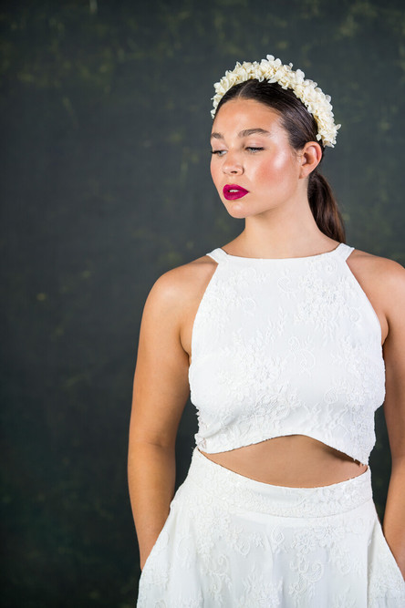 This contemporary bridal top has a lace frontage and illusion lace back. The on-trend curve at the front creates a subtle flash of tummy. Simple straps rest on the flattering collar bone area creating a modern shape. The Stevenson top features here with the Stevenson skirt. 
