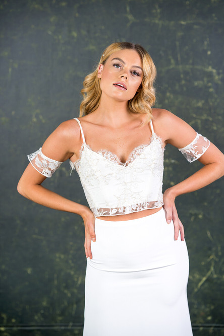 This pretty strappy top finds balance between structure and femininity. It is made with incredibly rare gold threaded bridal lace finished with a soft scalloped edge.

